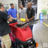 Sales representative trains factory employees to use Micro-HD scrubber