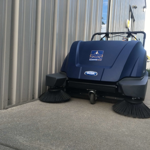 hammerhead-900sx-walk-behind-battery-powered-sweeper-close-to-wall HammerHead 900SX Walk-Behind Sweeper - Outdoors