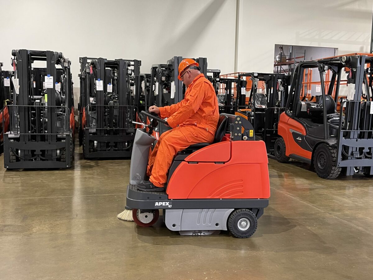 PowerBoss Apex 47 sweeping a warehouse