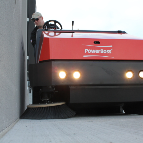 PowerBoss Atlas Sweeping Outdoors Along a Building