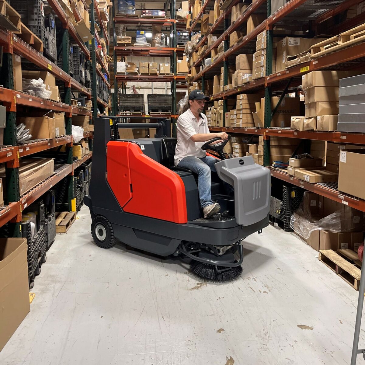 PowerBoss Sweepmaster 1500RH turning in a warehouse aisle