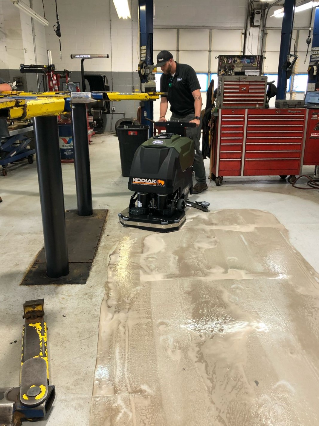 Kodiak K16 Walk-Behind Floor Scrubber Cleaning a Garage Floor