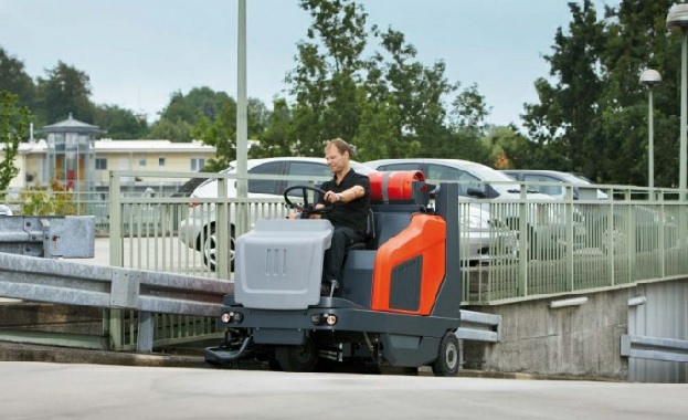 PowerBoss Sweepmaster 1500 RH ride-on vacuum sweeper on a paved outdoor area