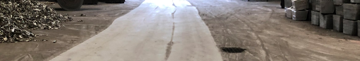 Cleanly swept path on floor of foundry by Bortek's PowerBoss Atlas.