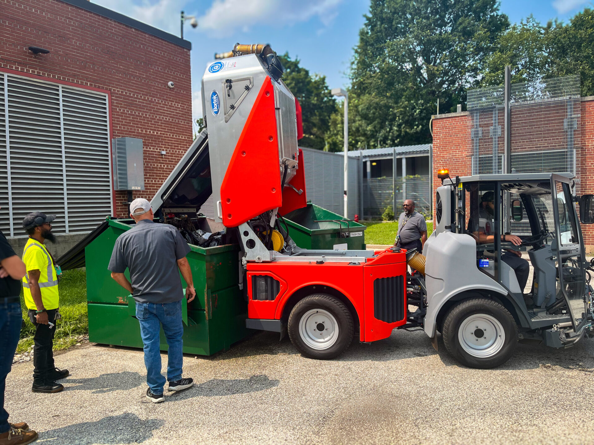 Compact street sweeper cleaning a parking lot